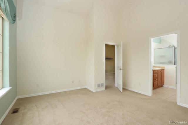 2238 Calais Dr Unit B, Longmont, CO 80504 - unfurnished bedroom with baseboards, light colored carpet, visible vents, and high vaulted ceiling