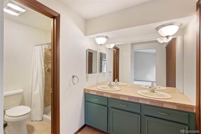 bathroom featuring a shower with shower curtain, a textured ceiling, vanity, and toilet