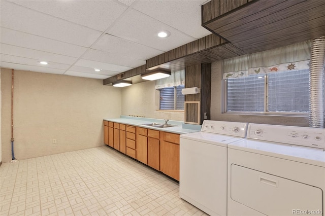 clothes washing area with sink and independent washer and dryer