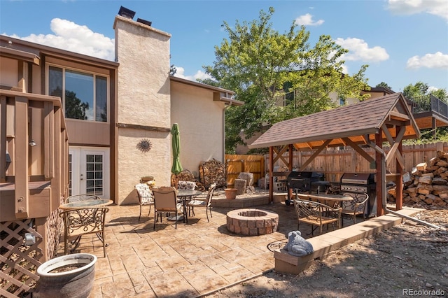 view of patio / terrace featuring grilling area, a gazebo, and an outdoor fire pit