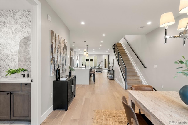 hall featuring light hardwood / wood-style flooring and sink