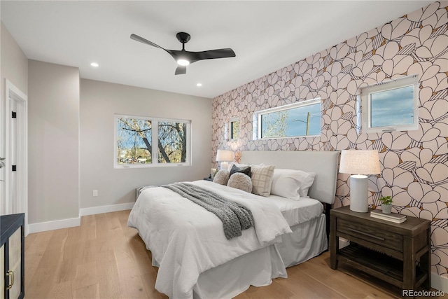 bedroom with ceiling fan and light hardwood / wood-style floors