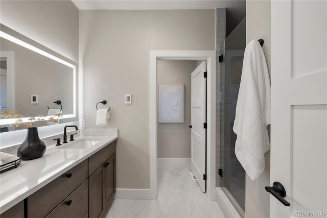 bathroom featuring vanity and an enclosed shower