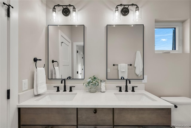 bathroom featuring vanity and toilet