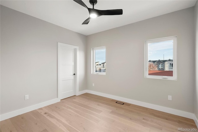 spare room with light hardwood / wood-style flooring and ceiling fan