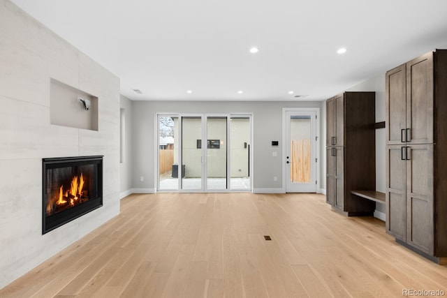 unfurnished living room with light hardwood / wood-style floors and a fireplace