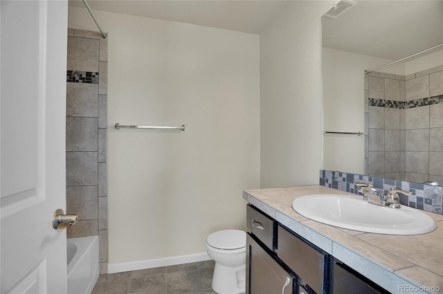 full bathroom featuring vanity, toilet, and tiled shower / bath combo