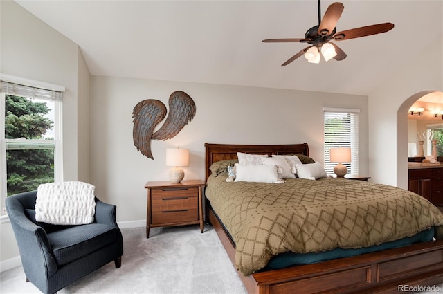 11056 W Rowland Ave, Littleton, CO 80127 - bedroom with light carpet, arched walkways, baseboards, ensuite bath, and a ceiling fan
