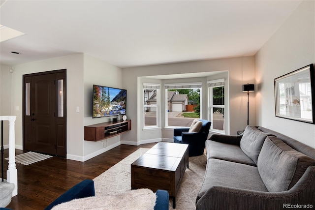 11056 W Rowland Ave, Littleton, CO 80127 - living area with dark wood-style flooring and baseboards