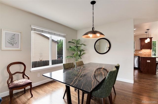 11056 W Rowland Ave, Littleton, CO 80127 - dining space featuring dark wood-style flooring and baseboards