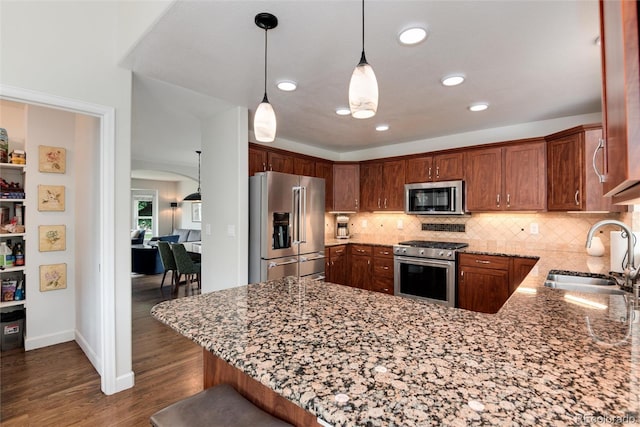 11056 W Rowland Ave, Littleton, CO 80127 - kitchen with high quality appliances, a sink, a peninsula, light stone countertops, and arched walkways
