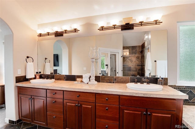11056 W Rowland Ave, Littleton, CO 80127 - bathroom with double vanity and a tile shower