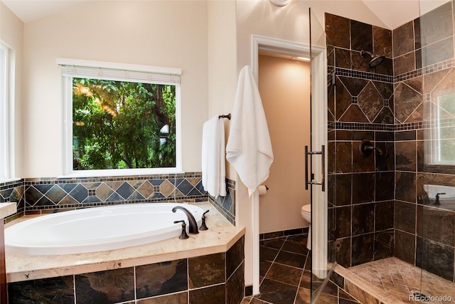 11056 W Rowland Ave, Littleton, CO 80127 - bathroom featuring a bath, a shower stall, toilet, lofted ceiling, and tile patterned floors