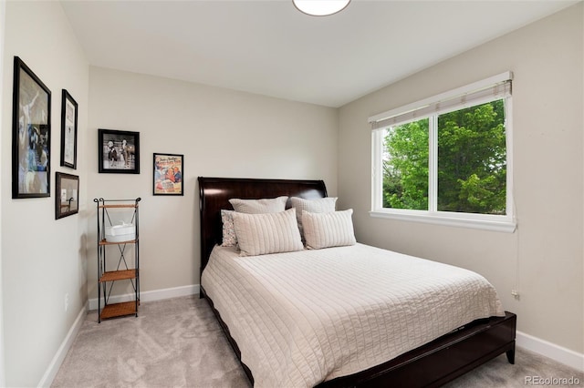 11056 W Rowland Ave, Littleton, CO 80127 - bedroom featuring light carpet and baseboards