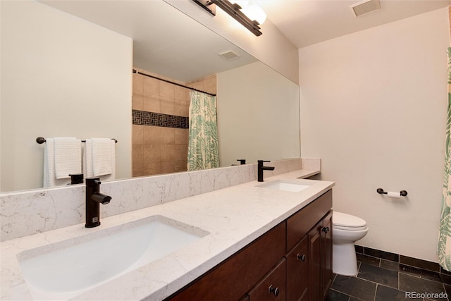 11056 W Rowland Ave, Littleton, CO 80127 - bathroom with double vanity, toilet, and a tile shower