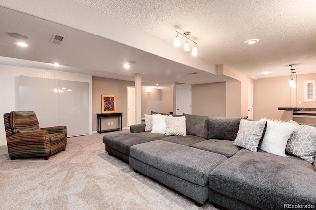 11056 W Rowland Ave, Littleton, CO 80127 - carpeted living room featuring a sink, a textured ceiling, and recessed lighting