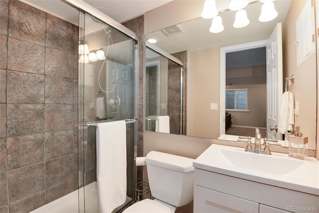 11056 W Rowland Ave, Littleton, CO 80127 - bathroom featuring vanity, toilet, and a shower stall