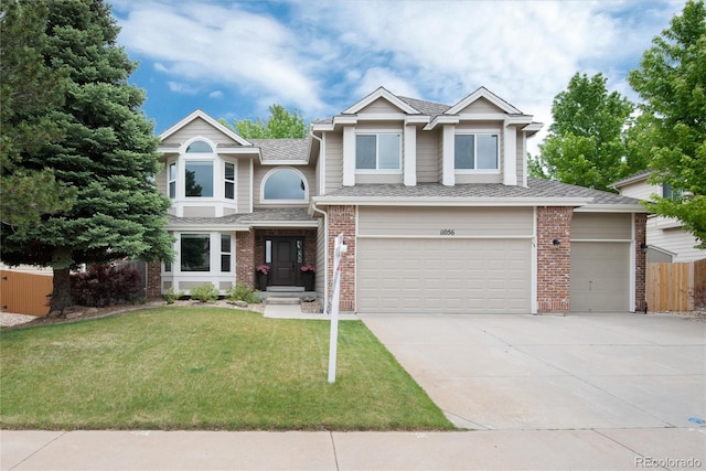 11056 W Rowland Ave, Littleton, CO 80127 - view of front of house with brick siding, concrete driveway, a garage, and a shingled roof