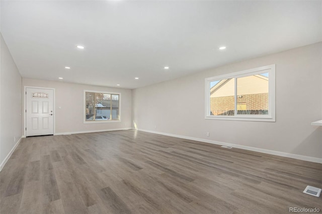 unfurnished living room with light wood-type flooring