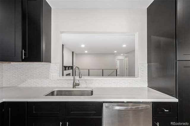 kitchen featuring dishwasher, backsplash, and sink