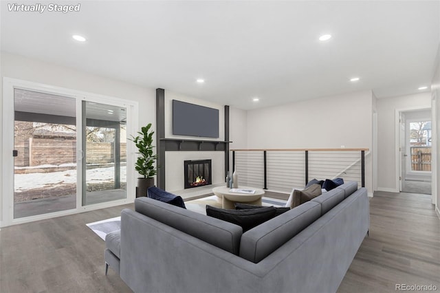 living room with a large fireplace and light hardwood / wood-style floors