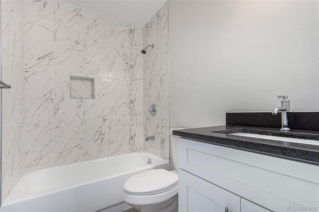 full bathroom featuring vanity, tiled shower / bath combo, and toilet