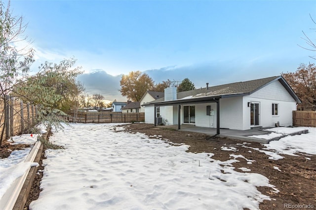 snow covered property featuring a patio