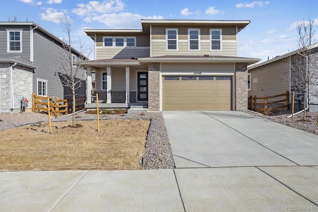 prairie-style house with fence, driveway, an attached garage, covered porch, and brick siding