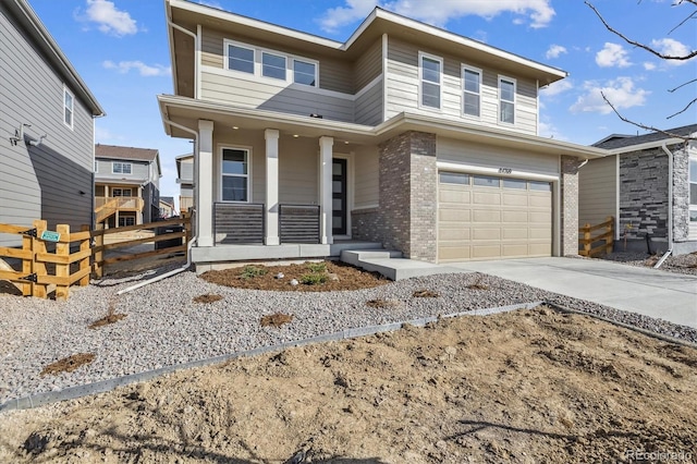 view of front of house featuring brick siding, fence, a porch, a garage, and driveway