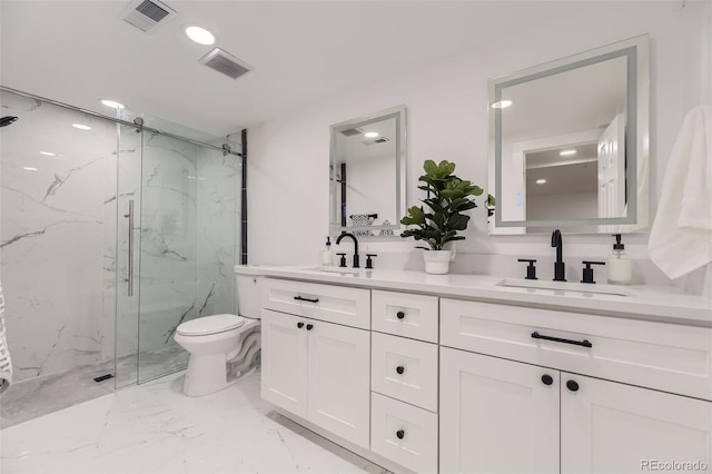 bathroom featuring vanity, toilet, and a shower with shower door