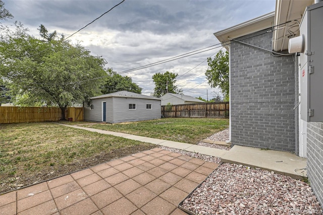 view of yard with an outbuilding and a patio area