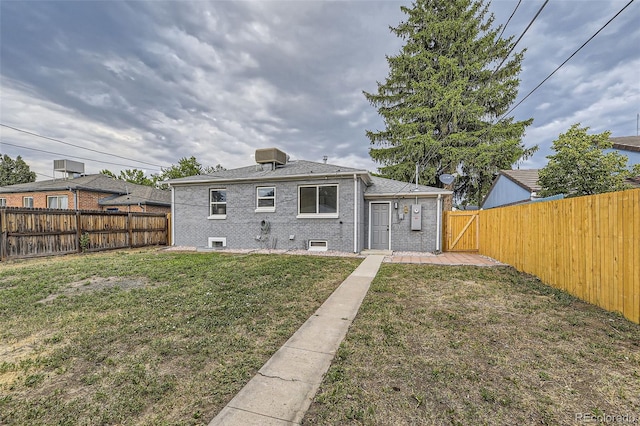 rear view of house with a lawn