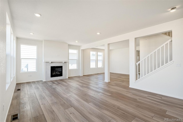 unfurnished living room with light hardwood / wood-style floors and a fireplace