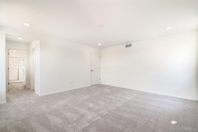 spare room featuring light colored carpet