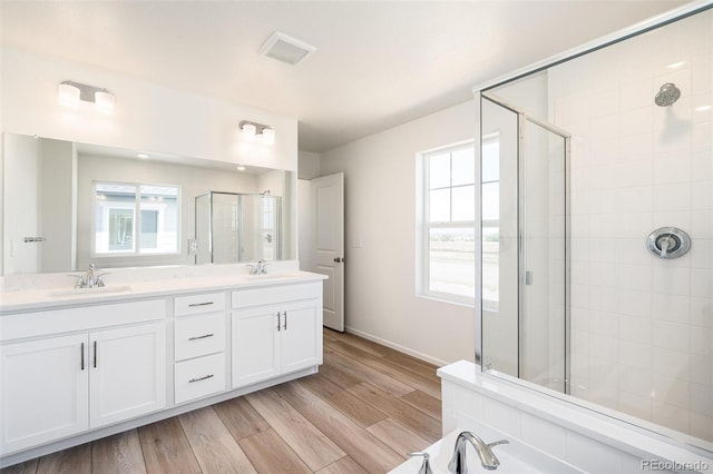 bathroom with vanity, wood-type flooring, and walk in shower