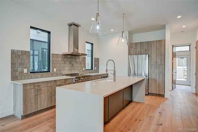 420 E Arkansas St, Buena Vista, CO 81211 - kitchen with appliances with stainless steel finishes, a sink, range hood, modern cabinets, and light countertops