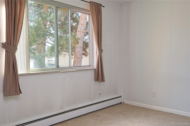 empty room featuring a wealth of natural light, a baseboard radiator, baseboards, and carpet