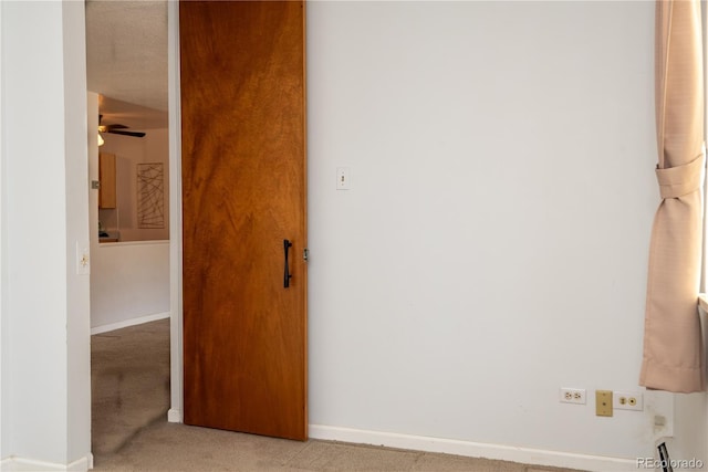 interior space with carpet and baseboards