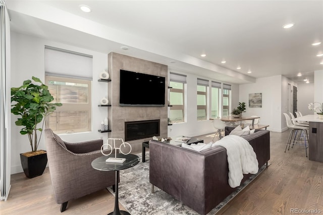 3586 S Ogden St, Englewood, CO 80113 - living area with wood finished floors, a tiled fireplace, and recessed lighting