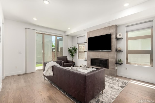3586 S Ogden St, Englewood, CO 80113 - living room featuring light wood finished floors, a high end fireplace, and recessed lighting