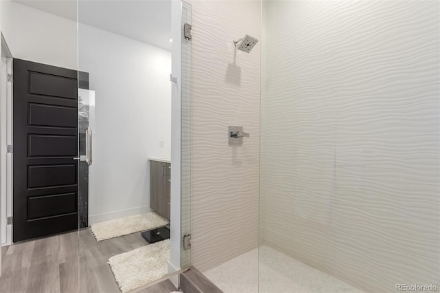 3586 S Ogden St, Englewood, CO 80113 - bathroom featuring a tile shower and wood finished floors
