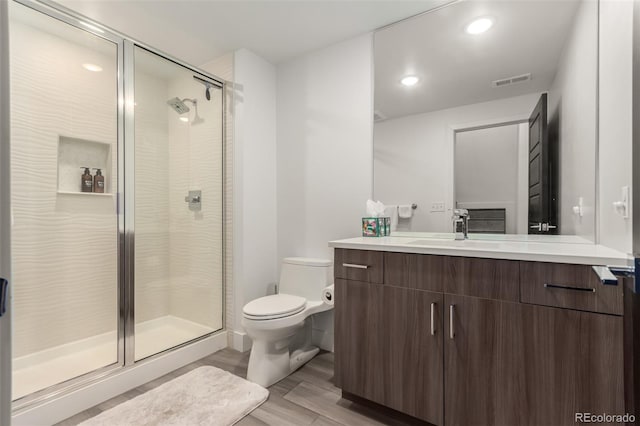 3586 S Ogden St, Englewood, CO 80113 - bathroom with vanity, a stall shower, wood finished floors, and recessed lighting