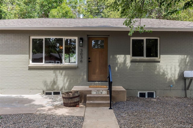 3036 Wolff St S, Denver, CO 80236 - doorway to property with brick siding and roof with shingles