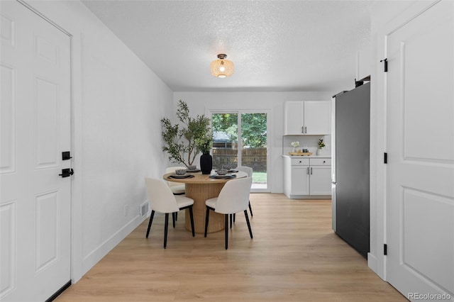 3036 Wolff St S, Denver, CO 80236 - dining area with light wood-style flooring and a textured ceiling