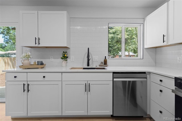 3036 Wolff St S, Denver, CO 80236 - kitchen with dishwasher, backsplash, light countertops, and white cabinetry