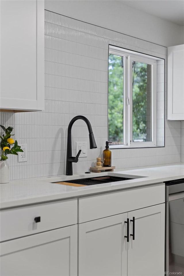 3036 Wolff St S, Denver, CO 80236 - kitchen with dishwasher, tasteful backsplash, light countertops, and white cabinetry
