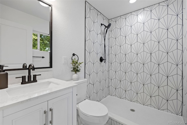 3036 Wolff St S, Denver, CO 80236 - full bath featuring tiled shower, vanity, and a textured wall