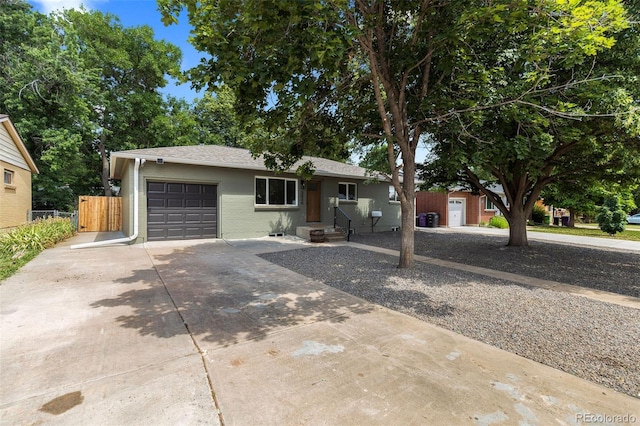 3036 Wolff St S, Denver, CO 80236 - ranch-style house with concrete driveway, an attached garage, brick siding, and a shingled roof