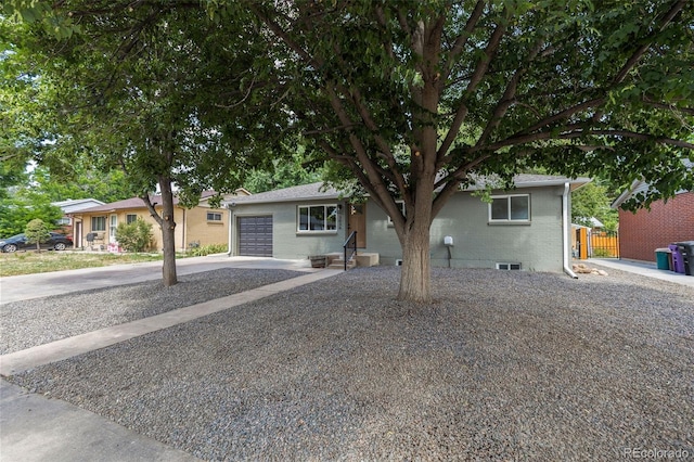 3036 Wolff St S, Denver, CO 80236 - view of front of home featuring a garage, brick siding, and concrete driveway