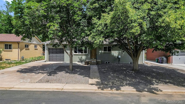 3036 Wolff St S, Denver, CO 80236 - view of front of house featuring driveway, a garage, and brick siding